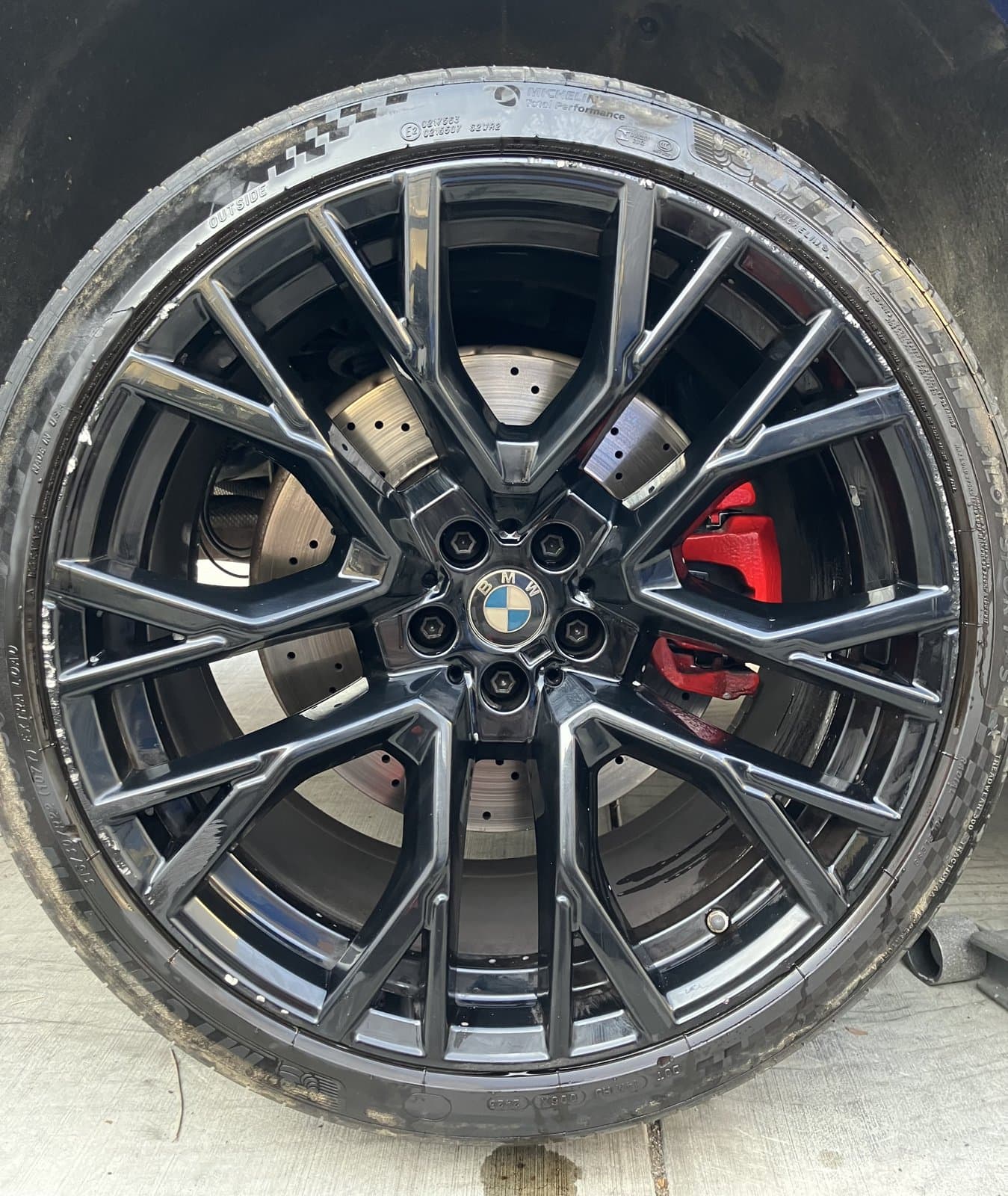 BMW M wheel with curb damage before restoration